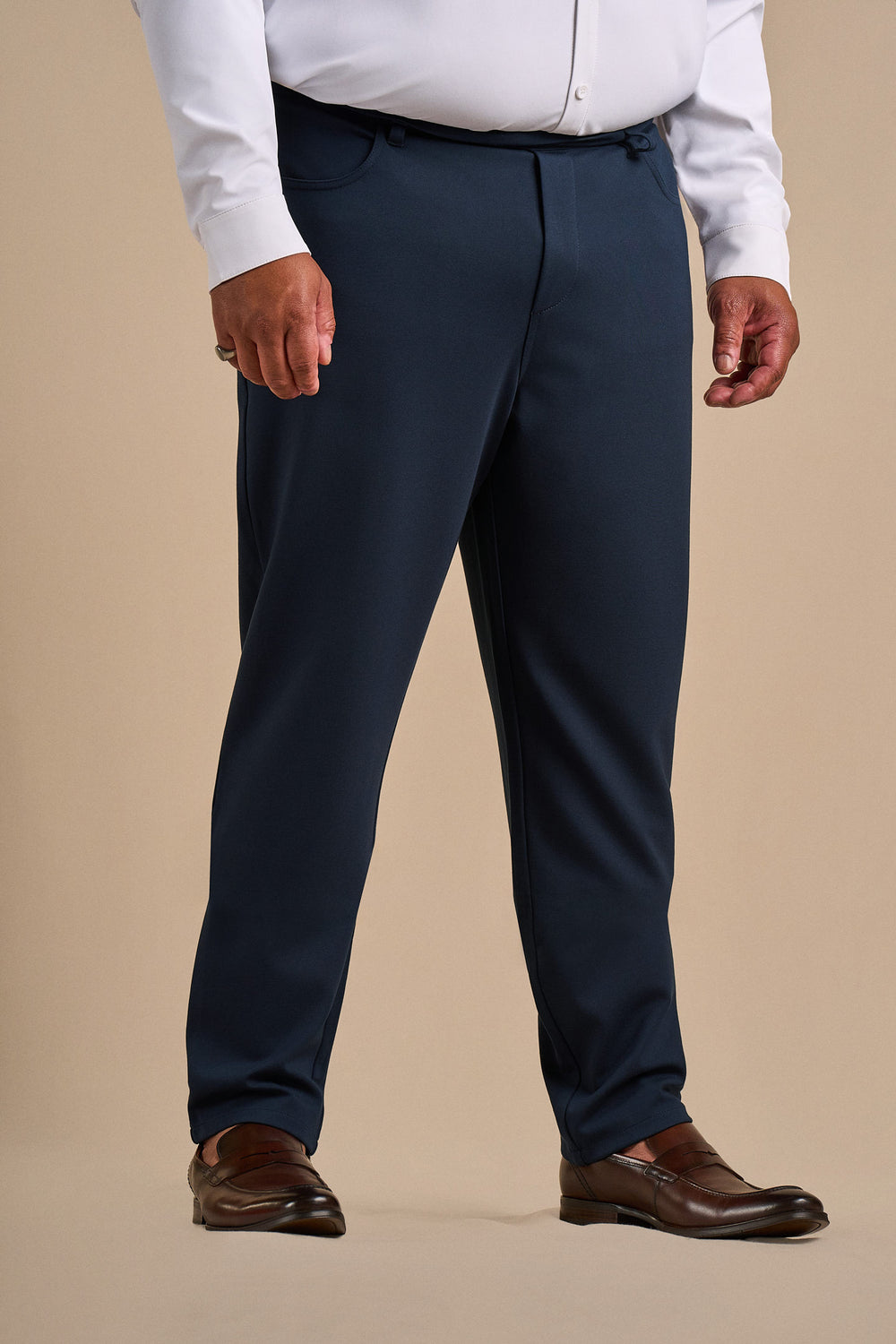 Front view of the navy SmartFit pant, styled with a white shirt and brown loafers.